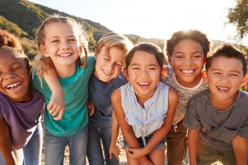 A group of kids showing off their good dental hygiene