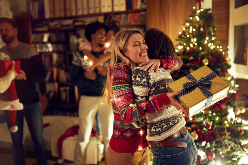 Friends exchanging gifts to relieve stress for better oral health